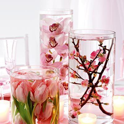 Flowers inside vessels full of water and placed on a table