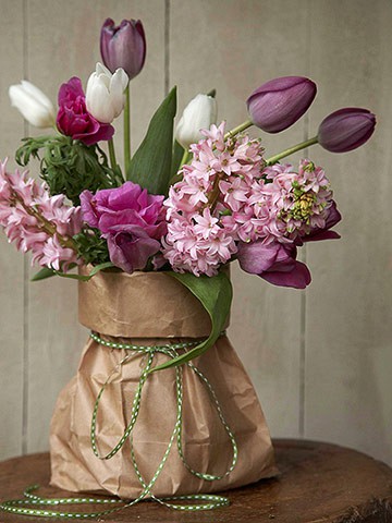 Fresh tulips placed in a paperbag instead of a traditional vase