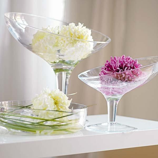 Gentle flowers placed in champagne glasses on a small home table