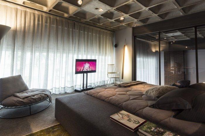 Loft bedrom in dark tones with stylish modern furniture