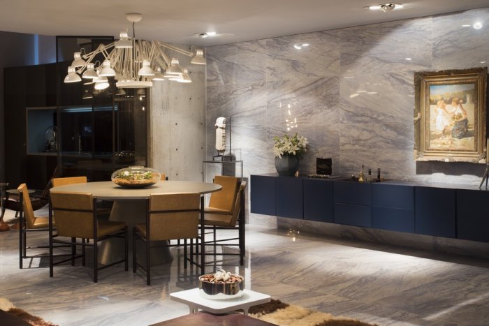 Luxury loft dining room with marble walls and contemporary pieces of art