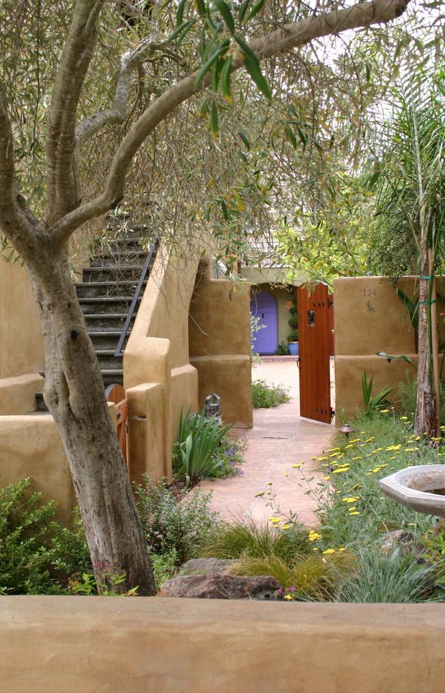 Mediterranean garden with entrance door leading inside the house