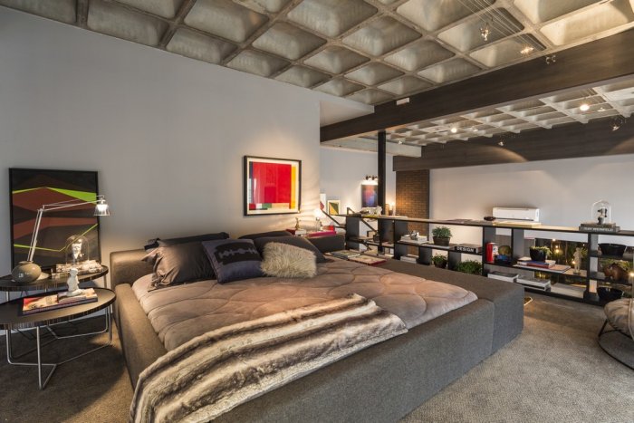 Modern loft bedroom with open wall towards the main volume of the property