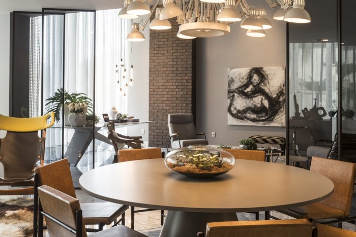 Modern loft dining room with stylish round table and interesting pendant