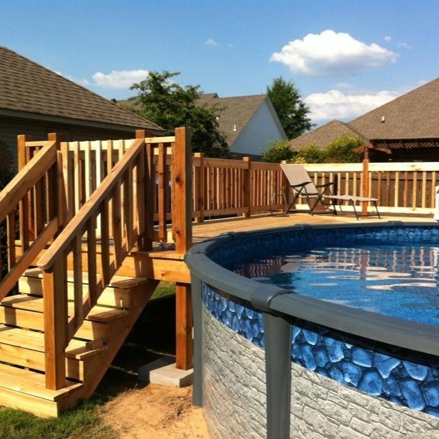 Above the ground pool with stairs made of wood