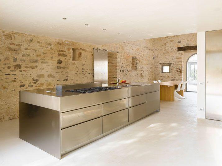 Authentic kitchen design with huge countertop and stone walls