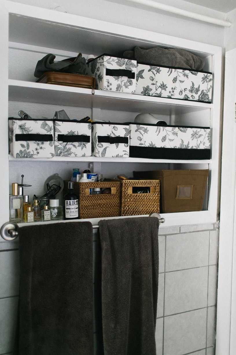 Bathroom storage boxes with various stuff in them