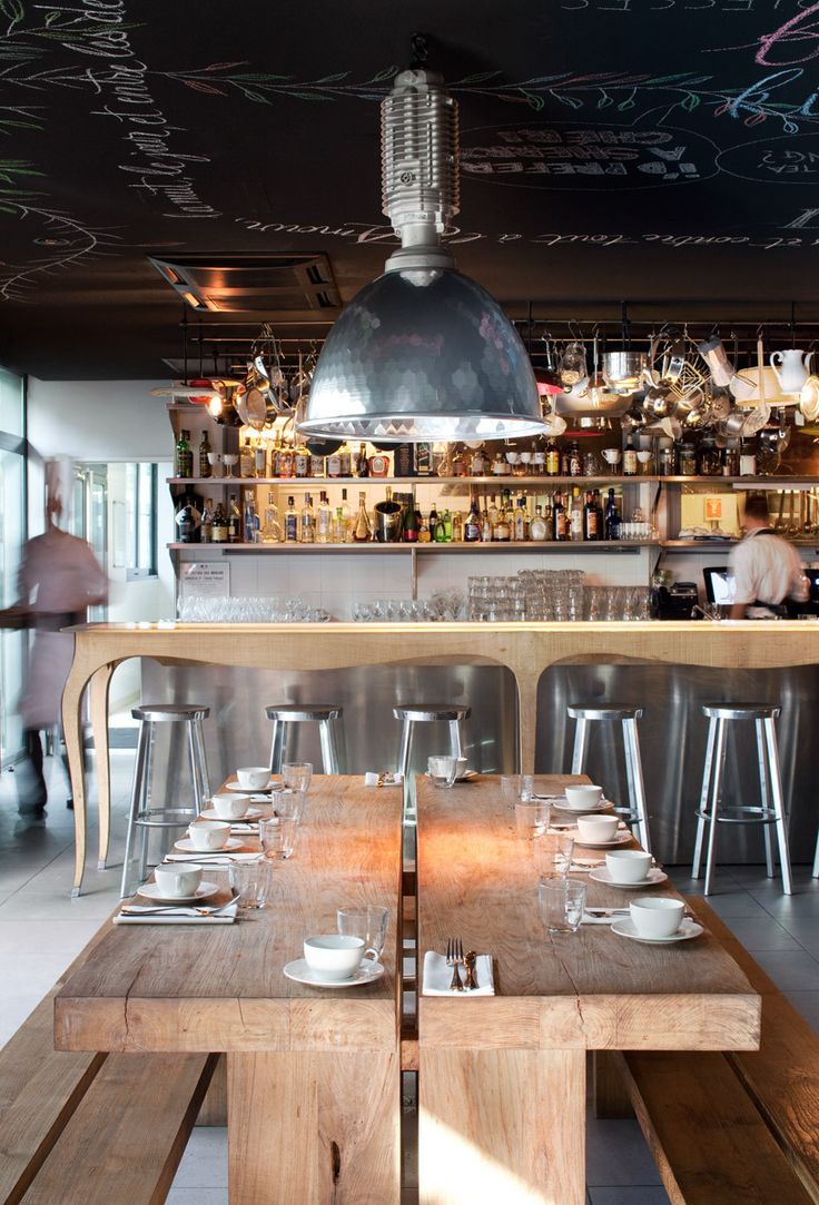 Coffee shop interior with massive wooden table and benches