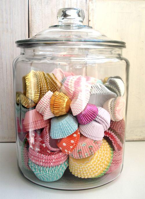 Colorful candy paper cups placed in a hurricane jar