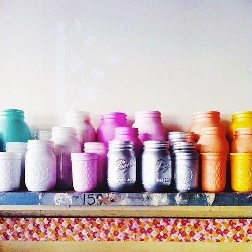Colorful jars placed on the fireplace mantel