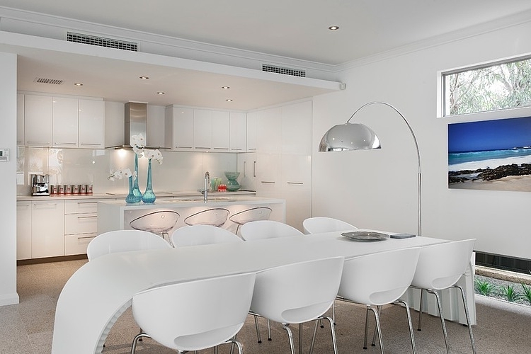 Contemporary dining room with white table and chairs