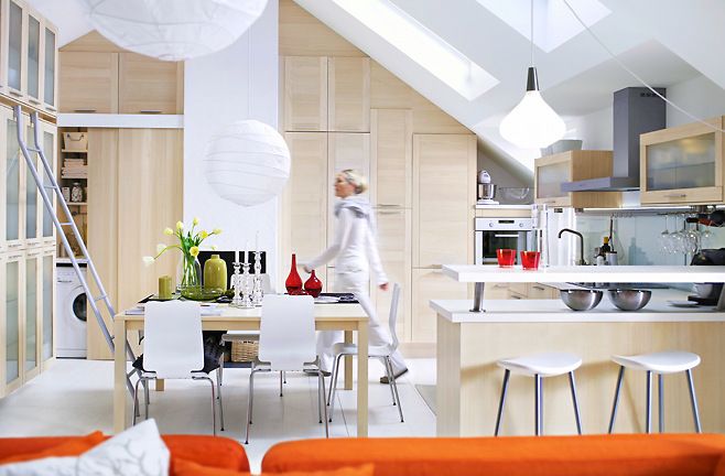 Contemporary white kitchen with orange accents in a flat