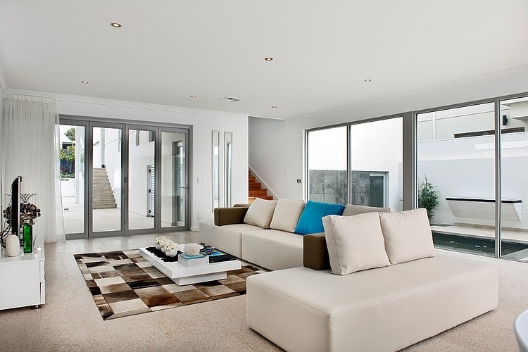 Contemporary white living room with comfortable sofas