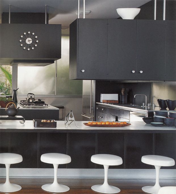 Dark kitchen design with whtie bar stools