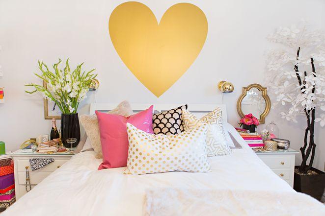 Decorative heart decall placed on the wall above the bed