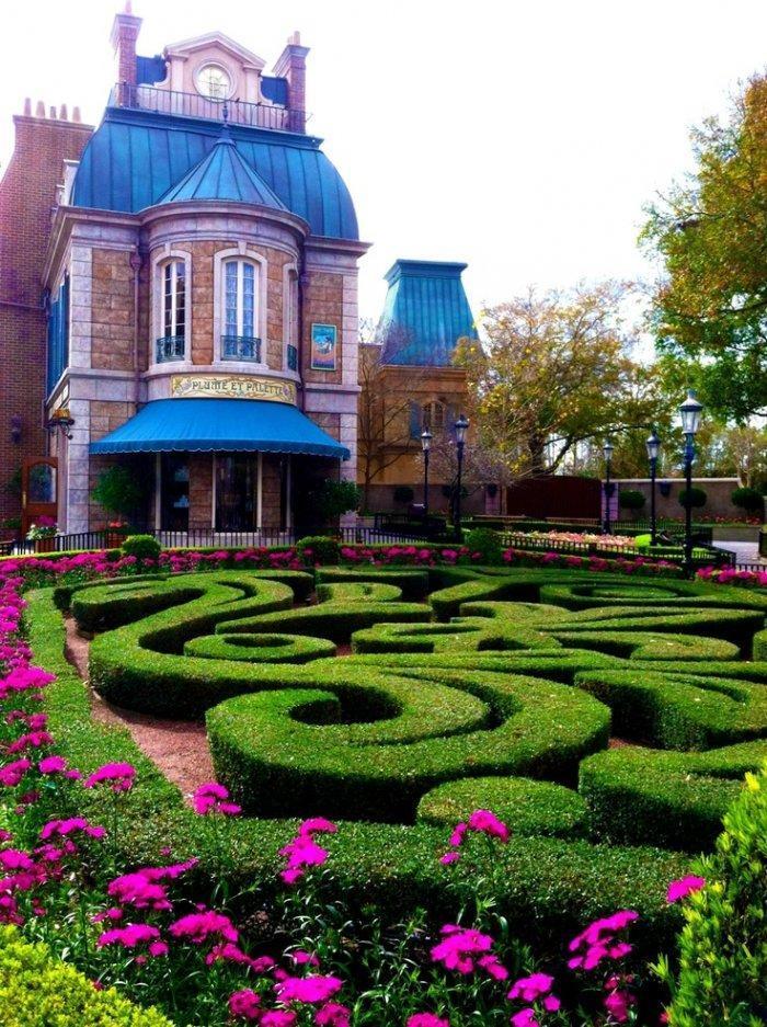 Huge Victorian house with labyrinth garden in front of it