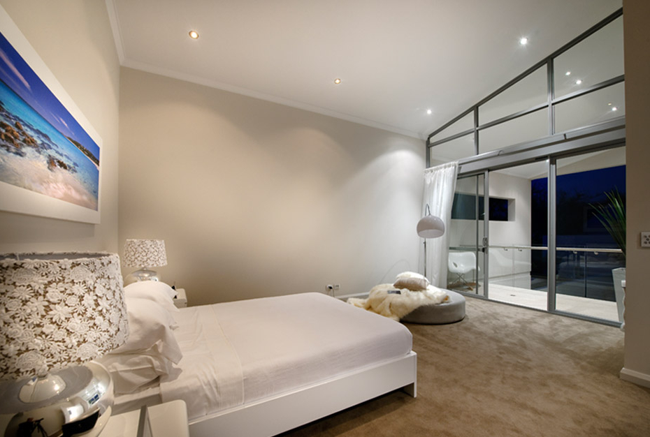 Luxurious white bedroom with view towards the nearby ocean