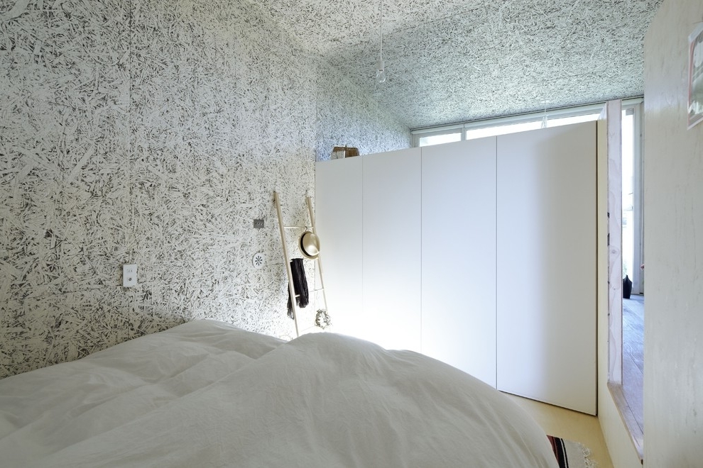 Minimalist bedroom with creative walls in white