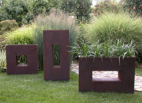 Minimalist flower pots in a garden outside the house