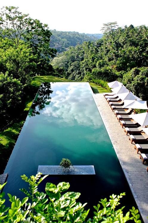 Minimalist swimming pool with lounge chairs and beautiful view