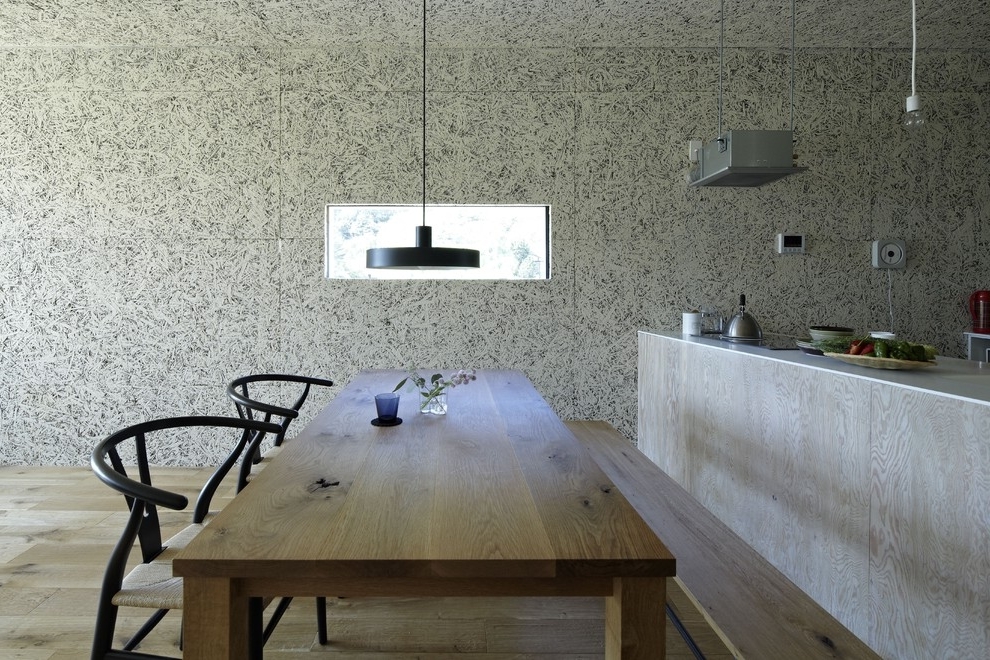 Mininalist dining room with massive wood table