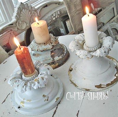 Shabby chic candles placed in vintage candleholders