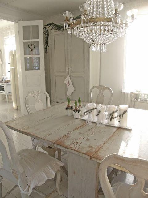 Shabby chic dining room with massive table and classic chandelier