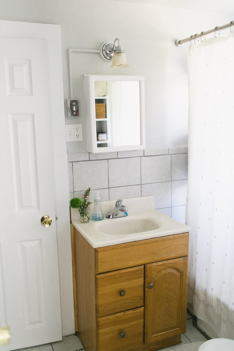 Small bathroom with tiny cabinet and sink