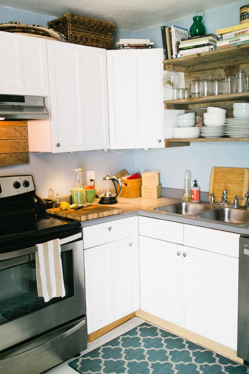 Small kitchen in white fills one of the corners