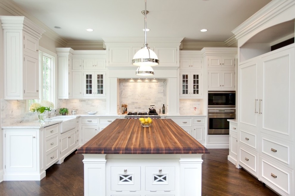 Traditional kitchen with toe kick furniture and island pilasters