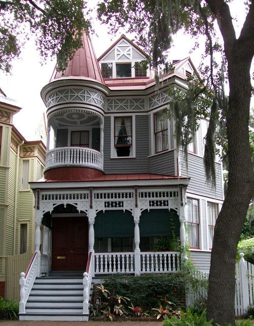 Two-storey Victorian house with white, pink and grey