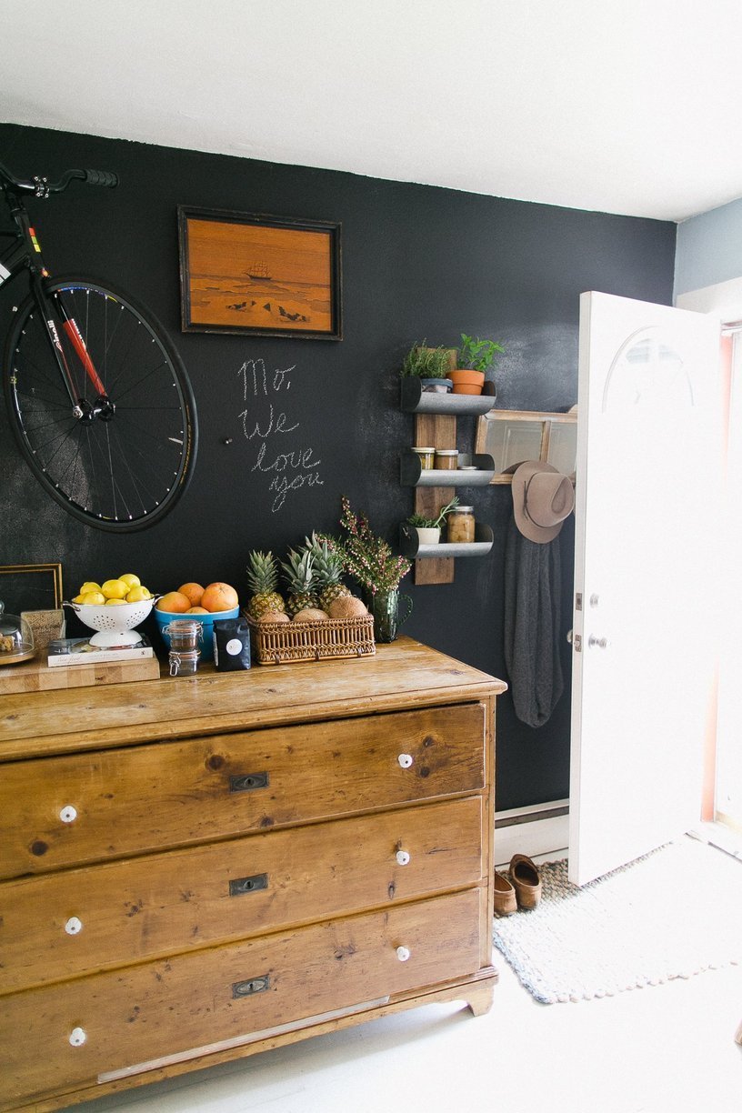 Vintage chest of drawers and black wall