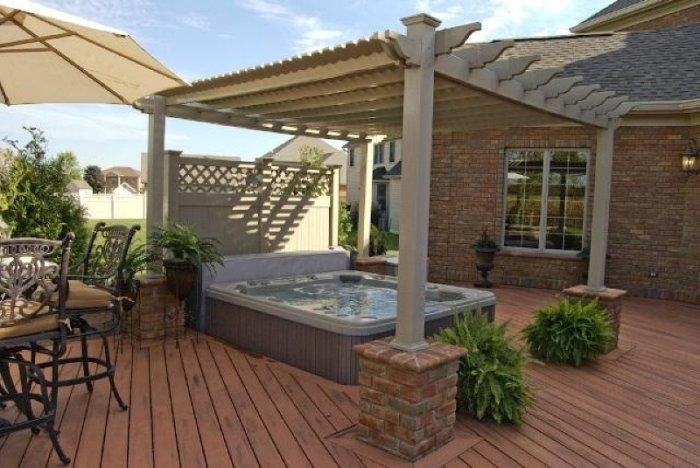 Vinyl pergola with jacuzzi on the front wooden deck