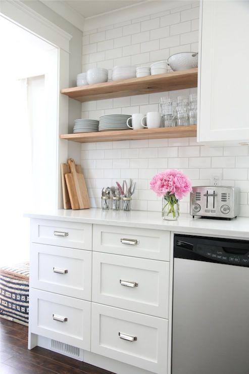 White kitchen cabinets and sweet pink flower decoration