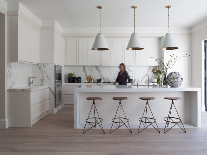 White pendants in a modern kitchen with traditional cabinets