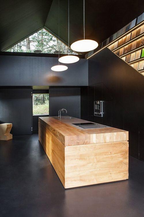 Wood kitchen island in a dark colored interior