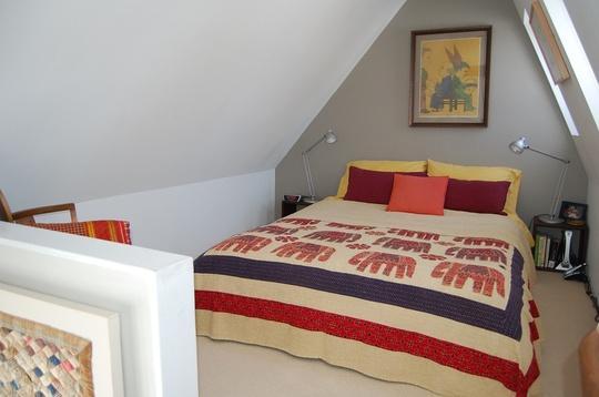 Casual attic bedroom - with modern bedsheets