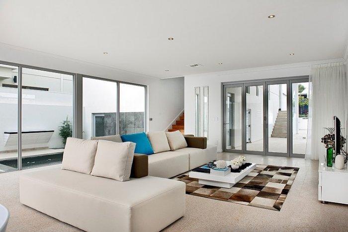 Contemporary white living room with comfortable sofas
