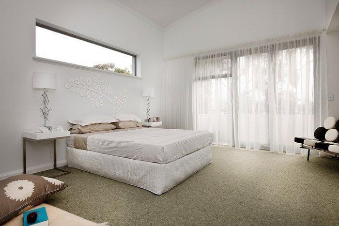 Cozy white bedroom in a coastal house in Australia