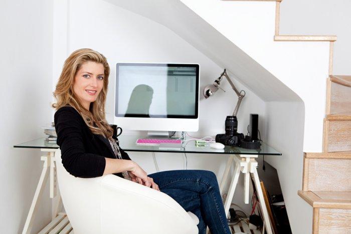 Home office beneath the stairs - with glass desk and modern chair