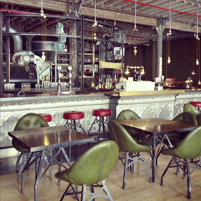 Industrial cafe interior - with green chairs and red bar stools