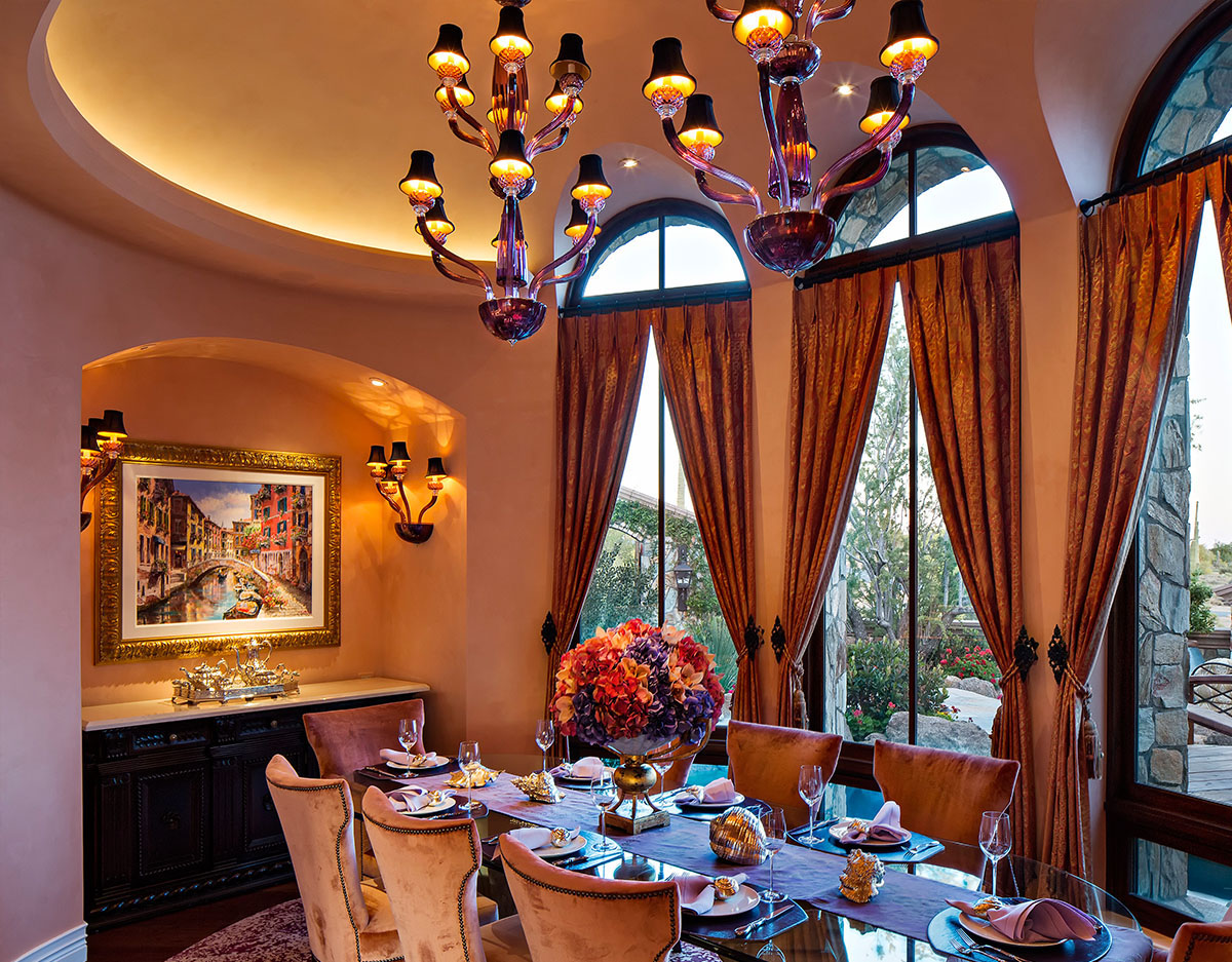 Luxurious tradtional dining room - with arched windows and art pendants