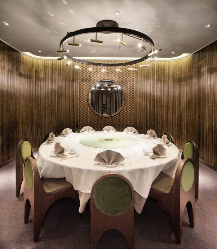 Restaurant architecture - round table for ten and amazing chandelier above