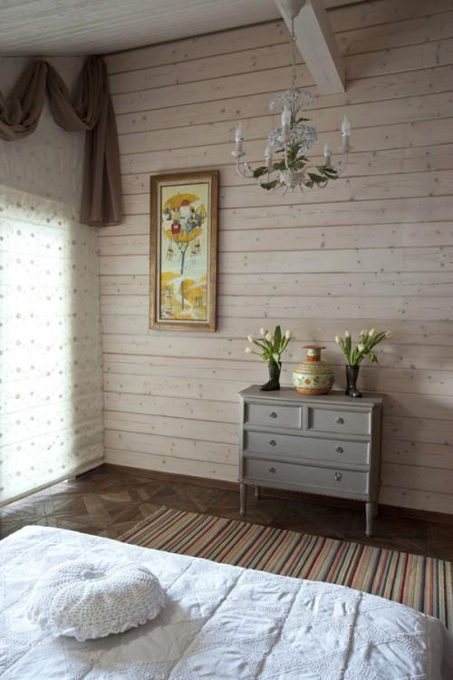 Summer villa - small cozy bedroom decorated with flowers and vintage wall art