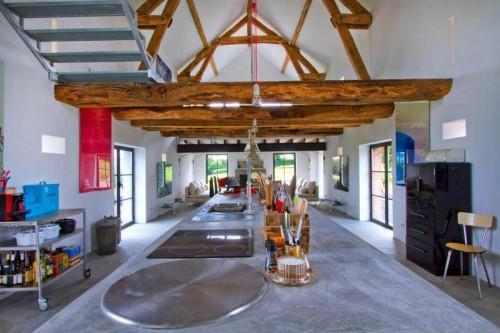 Summer villa with ultra modern open space and rustic barn beams on the ceiling