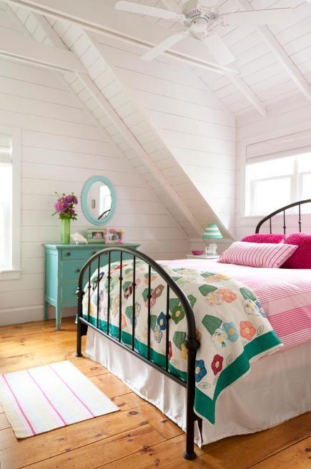 White attic bedroo - with colorful bed sheets