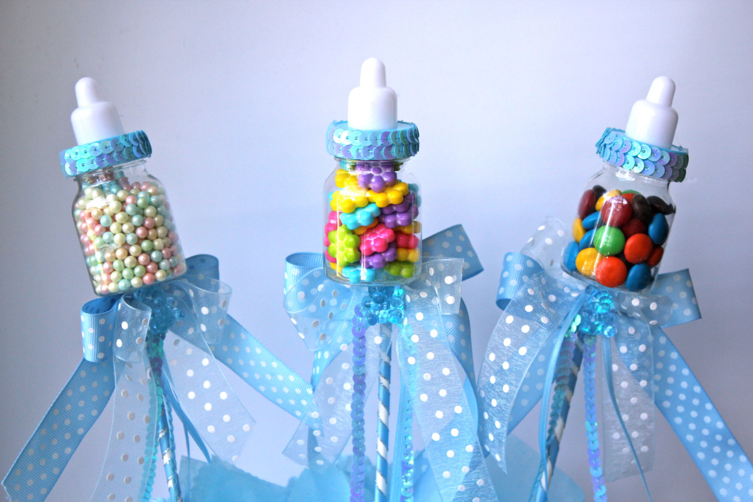 Baby shower feeding-bottles - with blue ribbons and sweets