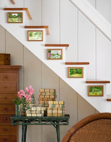 Cozy house white staircase - with small paintings on each step