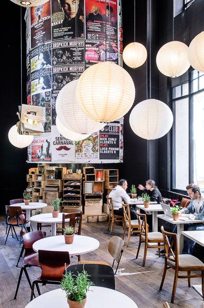 Creative modern coffee shop - with high ceoling and ball pendants