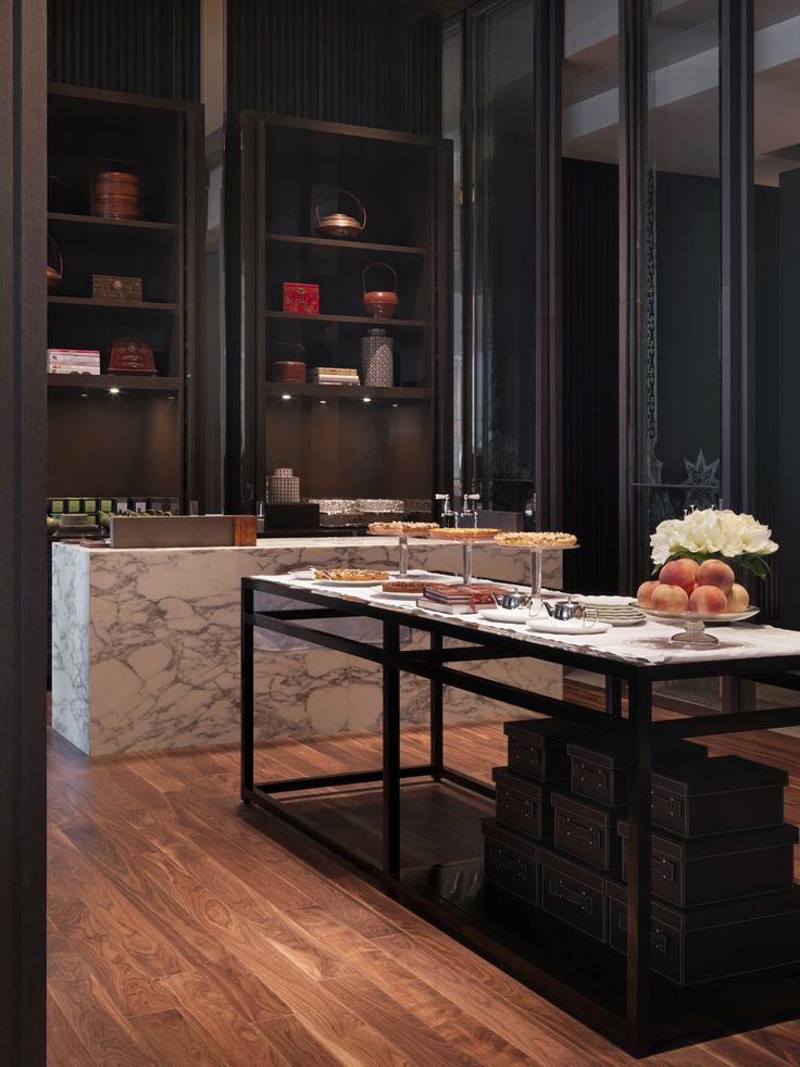 Luxurious dark kitchen - with small island and marble countertops